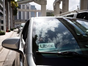 An Uber sticker is seen on a car windshield on the street in downtown Miami on January 9, 2020.