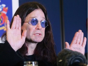 In this file photo taken on November 23, 2004, British rock star Ozzy Osbourne gestures during a Thames Valley Police press conference in Gerrards Cross, Britain,  after his house was broken into late 22 November.