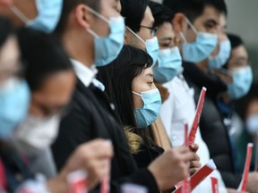 Local medical workers hold a strike near Queen Mary Hospital as they demand the city close its border with China to reduce the coronavirus spreading, in Hong Kong on February 3, 2020.