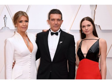 Nicole Kimpel, left, Antonio Banderas, centre, daughter Stella Banderas, right,  pose on the red carpet at the 92nd Annual Academy Awards on Feb. 9, 2020 in Hollywood, Calif.