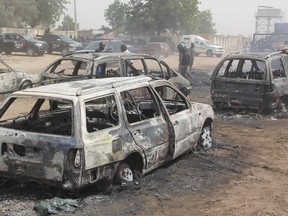 In this photograph taken in Auno on February 10, 2020, cars burnt down by suspected members of the Islamic State West Africa Province (ISWAP) during an attack on February 9, 2020, is seen.
