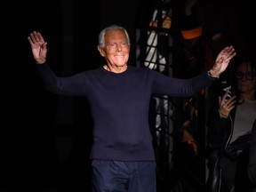 Italian fashion designer Giorgio Armani acknowledges applause following the presentation of Emporio Armani's Women Fall/Winter 2020 fashion collection on Feb. 21, 2020, in Milan.