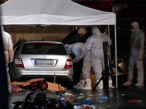 Police officers investigate the car of the man who drove into a carnival procession on February 24, 2020 in Volkmarsen near Kassel, central Germany.