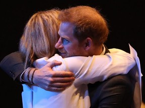 Britain's Prince Harry (R), Duke of Sussex, is greeted with a hug as he attends a sustainable tourism summit at the Edinburgh International Conference Centre in Edinburgh on February 26, 2020.