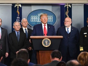 US President Donald Trump (C) speaks at a news conference with members of the Centers for Disease Control and Prevention(CDC) on the COVID-19 outbreak at the White House in Washington, DC on February 29, 2020.