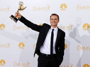 Phil Keoghan poses with his Outstanding Reality-Competition Program award for the CBS show "The Amazing Race" at the 66th Primetime Emmy Awards in Los Angeles, California August 25, 2014. (REUTERS/Mike Blake)