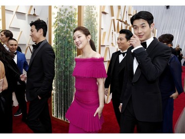 Park So-dam, second from right and Choi Woo-shik, right, walk on the red carpet during the Oscars arrivals at the 92nd Academy Awards in  Los Angeles, Calif., Feb. 9, 2020.