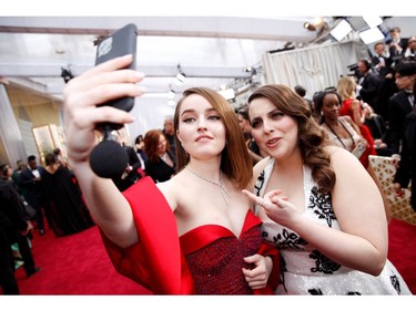 Kaitlin Dever and Beanie Feldstein pose for a selfie on the red carpet at the 92nd Annual Academy Awards on Feb. 9, 2020 in Hollywood, Calif.