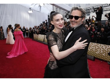 Joaquin Phoenix and Rooney Mara embrace on the red carpet at the 92nd Annual Academy Awards on Feb. 9, 2020 in Hollywood, Calif.