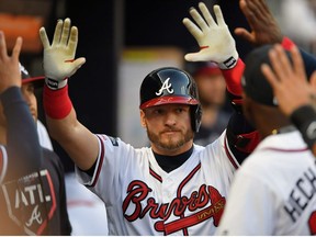 Atlanta Braves third baseman Josh Donaldson (20) is greeted in the dugout after hitting a home run against the St. Louis Cardinals in the fourth inning of game five of the 2019 NLDS playoff baseball series at SunTrust Park.