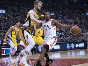 Toronto Raptors guard Kyle Lowry controls a ball as Indiana Pacers forward Domantas Sabonis defends during the second quarter at Scotiabank Arena.