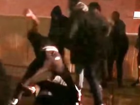 A man is attacked by students from Malcolm X. Shabazz High School in Newark, N.J. (Video screen grab)