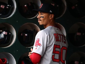 Mookie Betts of the Boston Red Sox stands in the dugout before their game against the Oakland Athletics at Oakland-Alameda County Coliseum on April 3, 2019 in Oakland. (Ezra Shaw/Getty Images)