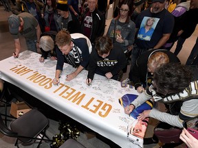 Fans sign a banner for St. Louis Blues defenceman Jay Bouwmeester before a game at T-Mobile Arena on February 13, 2020 in Las Vegas. (Ethan Miller/Getty Images)