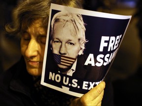A demonstrator holds a placard in support of WikiLeaks founder Julian Assange during a protest against his extradition to the United States, in Barcelona, Spain February 24, 2020.