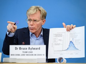 Team leader of the joint mission between World Health Organization (WHO) and China on COVID-19, Bruce Aylward, shows graphics during a press conference at the WHO headquarters in Geneva on February 25, 2020. (FABRICE COFFRINI/AFP via Getty Images)