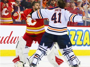Calgary Flames goalie Cam Talbot and Edmonton Oilers goalie Mike Smith fight during NHL action in Calgary on Saturday, Feb. 1, 2020.