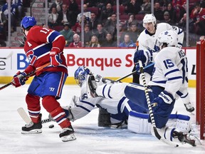 Maple Leafs goaltender Jack Campbell dives for the puck near Brendan Gallagher (11) of the Montreal Canadiens during the second period at the Bell Centre on Saturday night. (Minas Panagiotakis/Getty Images)
