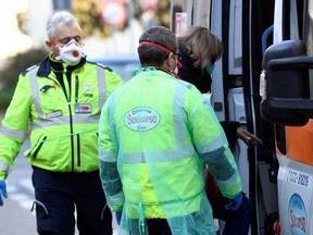 A woman is taken into an ambulance amid a coronavirus outbreak in northern Italy, in Casalpusterlengo, February 22, 2020.