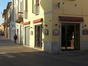 People walk down an empty street in the village of Codogno after officials told residents to stay home and suspend public activities as 14 cases of coronavirus are confirmed in northern Italy, in this still image taken from video in the province of Lodi, Italy, February 21, 2020.