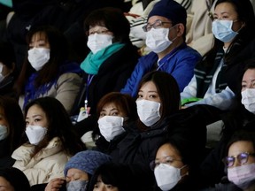 Spectators wearing masks to prevent contacting to a new coronavirus attend Four Continents Figure Skating Championships 2020 in Seoul, South Korea, February 7, 2020.