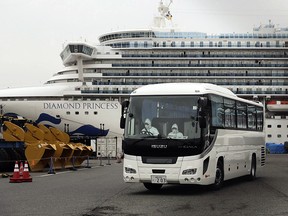 A bus leaves a port where the quarantined Diamond Princess is docked Saturday, Feb. 15, 2020, in Yokohama, near Tokyo. (AP Photo/Jae C. Hong)