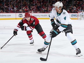Brenden Dillon of the San Jose Sharks skates with the puck past Clayton Keller of the Arizona Coyotes a game at Gila River Arena on January 14, 2020 in Glendale, Arizona. (Christian Petersen/Getty Images)