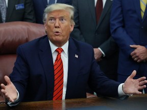 U.S. President Donald Trump speaks to reporters on the topic of Roger Stone, House Intelligence Committee Chairman Adam Schiff, and 2020 presidential candidates, after signing the Supporting Veterans in STEM Careers Act in the Oval Office at the White House in Washington, D.C., on Tuesday, Feb. 11, 2020.