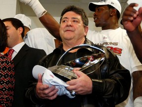 Former 49ers owner Edward J. DeBartolo, Jr. holds the NFC championship trophy as he congratulates players in the locker room after the 49ers defeated the Falcons in the NFC Championship in Atlanta, on Jan. 20, 2013.