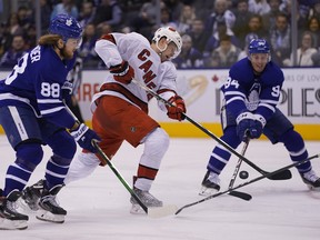 Carolina Hurricanes forward Warren Foegele shoots the puck as Toronto Maple Leafs forward William Nylander (left) and defenceman Tyson Barrie defend during the second period at Scotiabank Arena on Saturday. (John E. Sokolowski/USA TODAY Sports)