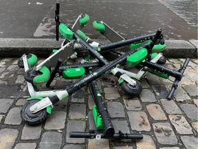 Dock-free electric scooters by California-based bicycle sharing service Lime are stacked on Parisian cobblestones in a street in Paris, France, May 19, 2019.