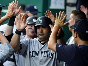 Kendrys Morales (front) and Clint Frazier (back) of the New York Yankees are congratulated by teammates after scoring on a Austin Romine single in the second inning against the Kansas City Royals during game two of a doubleheader at Kauffman Stadium on May 25, 2019 in Kansas City, Miss. (Ed Zurga/Getty Images)