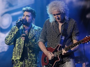 Adam Lambert, left, performs with Brian May of Queen during Fire Fight Australia at ANZ Stadium on Feb. 16, 2020 in Sydney, Australia.