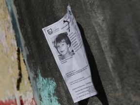 A missing person flyer is seen as people arrive at the home of seven-year-old Fatima Cecilia Aldrighett, who went missing on Feb. 11 and whose body was discovered over the weekend inside a plastic garbage bag, in Mexico City, Mexico, Feb. 17, 2020.