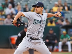 Seattle Mariners starting pitcher Marco Gonzales (7) pitches the ball against the Oakland Athletics during the first inning at Oakland Coliseum in Oakland, Calif., on June 14, 2019.