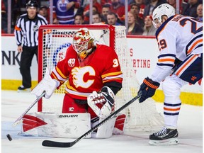 Calgary Flames goaltender Cam Talbot  makes a save as Edmonton Oilers centre Leon Draisaitl tries to score during the second period at Scotiabank Saddledome.