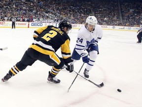 Pittsburgh Penguins defenseman Chad Ruhwedel and Toronto Maple Leafs right wing Kasperi Kapanen chase the puck during the first period at PPG PAINTS Arena.