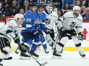 Winnipeg Jets forwards Jack Roslovic (left) and Andrew Copp set up in front of Los Angeles Kings goaltender Calvin Petersen Tuesday night. Kevin King/Winnipeg Sun