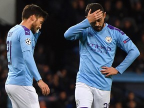 In this file photo taken on October 1, 2019 Manchester City midfielders David Silva (left) and Bernardo Silva react to a missed chance during the UEFA Champions League match against Dinamo Zagreb at the Etihad Stadium in Manchester. (ANTHONY DEVLIN/AFP via Getty Images)