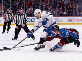 Lightning defenceman Erik Cernak (81) and Avalanche right wing Mikko Rantanen (96) battle for the puck during first period NHL action at the Pepsi Center in Denver, on Monday, Feb. 17, 2020.