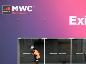 A worker cleans glass doors at the Mobile World Congress MWC venue at the Fira Barcelona Montjuic centre in Barcelona, on Wednesday, Feb. 12, 2020.