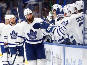 Toronto Maple Leafs defenseman Jake Muzzin is congratulated after he scored a goal against the Tampa Bay Lightning during the first period at Amalie Arena, Feb. 25, 2020. (Kim Klement-USA TODAY Sports)