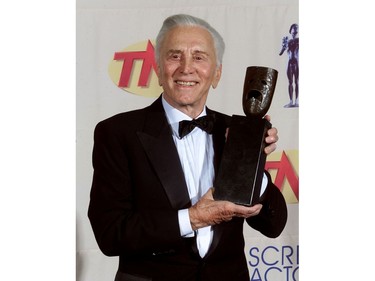 Actor Kirk Douglas poses with the Screen Actors Guild Life Achievement Award which was presented to him at the 5th Annual Screen Actors Guild Awards in Los Angeles March 7, 1999. (REUTERS/Fred Prouser/File Photo)