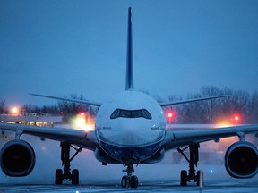 A plane carrying Canadian citizens from the centre of the global novel coronavirus outbreak in Wuhan, China, arrives at CFB Trenton, February 7, 2020. (Justin Tang/Pool via REUTERS)