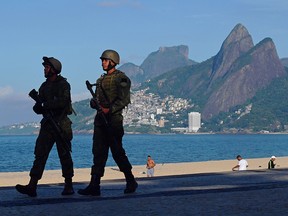 In this file photo taken on April 14, 2018, Brazilian soldiers patrol on Ipanema beach in Rio de Janeiro on April 14, 2018. (CARL DE SOUZA/AFP via Getty Images)