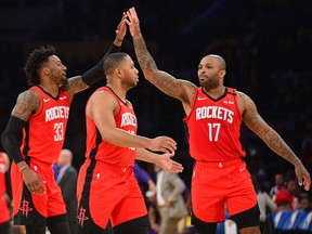 Houston Rockets forward Robert Covington and forward P.J. Tucker celebrate the three-point basket scored by guard Eric Gordon against the Los Angeles Lakers during the second half at Staples Center in Los Angeles on Thursday, Feb. 6, 2020.