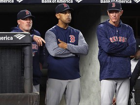 Boston Red Sox pitching coach Dana LeVangie, left, manager Alex Cora, centre, and bench coach Ron Roenicke react during a game against the New York Yankees in New York, Wednesday, May 9, 2018. (AP Photo/Kathy Willens)