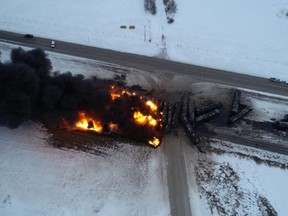Fire and smoke rise from the site where a train derailed near Guernsey, Sask., in a Feb. 6, 2020, handout image.