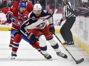 Montreal Canadiens forward Tomas Tatar slashes Columbus Blue Jackets defenceman Seth Jones (3) at the Bell Centre. (Eric Bolte-USA TODAY Sports)