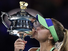 Sofia Kenin kisses the Daphne Akhurst Memorial Cup after defeating Spain's Garbine Muguruza in the women's final of the Australian Open in Melbourne, Australia, on Saturday, Feb. 1, 2020.